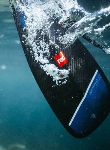 A Red Equipment paddle cutting into water from an underwater perspective.